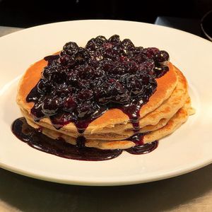 Vegan almond milk oat pancakes with a berry compote  at 80 20 Health Bar & Kitchen in Bolton
