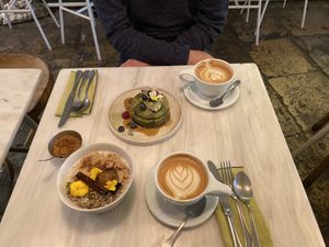 Café Latte, Matcha pancakes , baked apple porridge  at Comoba in Lisbon