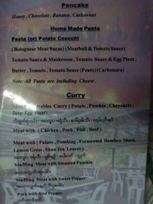 serves pancake,  curry and pasta at Home Again in Kalaw