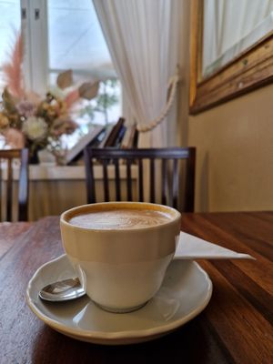 Cappuccino with soy milk, view to the courtyard. at Café Engel in Helsinki