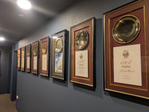 Gold Plate awards on one wall near the toilets..... at Hanuman in Darwin
