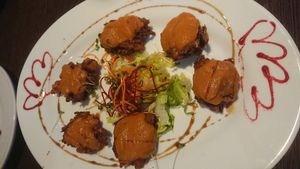 Street food starter - fried vegetable koftas with spicy curry sauce at Da Gurkha Fine Dining in Liverpool