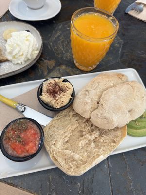 Sandwich with tomato, handmade hummus and avocado + orange juice   at Almazen Cafe in Sevilla