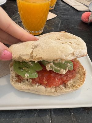 Sandwich with tomato, handmade hummus and avocado + orange juicee  at Almazen Cafe in Sevilla