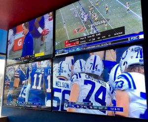 Televisions and large projection screens display every game! at Arooga's in East Brunswick