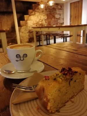 Oat milk latte and lemon & poppy seed cake (one of 7 vegan cakes available) at Jaunty Goat - Bridge St in Chester