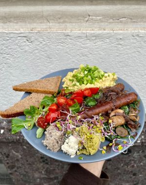 TOFU PLATE
scrambled tofu, vegan sausage, caramelized onion, blanched spinach with champignons and garlic, tomatoes, 3 kinds of spread: cream cheese, 
pea & champignons, rye brea at Relax na Wilczej in Warsaw