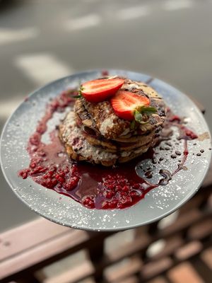 PANCAKES (V) - with stracciatella cream, chocolate, espresso sauce, spicy coconut caramel & strawberries at Relax na Wilczej in Warsaw