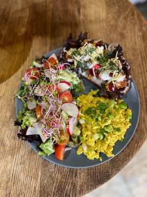 TOFU SCRAMBLE (V) -sourdough toast with whipped vegan feta, chanterelles, mustard seed, cranberry, salad, smoked vegan cheddar, dill, chives at Relax na Wilczej in Warsaw