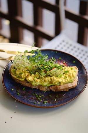 TOFU SCRAMBLE TOAST (V) sourdough wheat-rye bread from ŻYTO/avocado/tofu scramble at Relax na Wilczej in Warsaw
