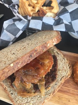Impossible Burger with sautéed onions & fried green tomato on a multi grain bread with waffle fries  at Exit Zero Filling Station in Cape May