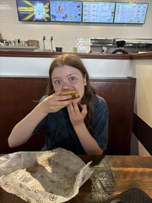 The second-born finally growing into her burger. 🥹  at Plant Power Fast Food in Redlands