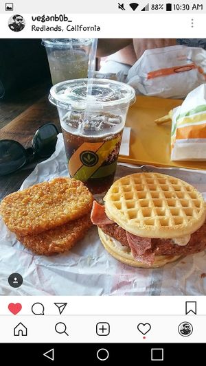 Crispy chickn sandwhich with bacon and maple sauce hashbrowns and a root beer at Plant Power Fast Food in Redlands