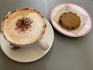Cappuccino with almond milk and homemade cookie at Umami Good Food in Tenerife
