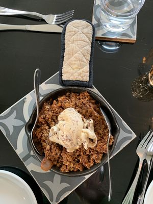 Apple crisp for dessert is served hot in a cast iron skillet. Wonderful ! at Sage and Cinder in Mukilteo