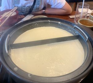 Making yuba at the table  at Okabeya in Kyoto