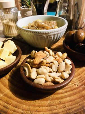 Queso, humus con cebolla caramelizada, frutos secos, aceitunas.... una parte de la tabla vegana 🌱  at La Casa Organica in Santiago