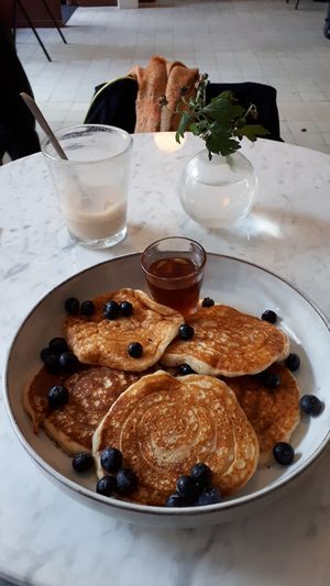 Vegan pancakes with maple syrup and half empty cafe latte with oat milk at Green Hippo in Helsinki