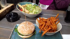 A vegan burger with sweet potato fries, and the vegan salad. at Hans im Glück in Leipzig