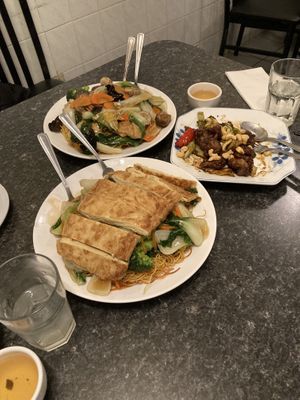 Duck (in front), Buddha’s special on crispy noodle (back left), kung pao chicken (half eaten, back right) at Buddha's Vegan Restaurant in Toronto