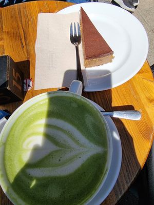 Matcha latte and vg cake at Kelet Kávézó és Galéria in Budapest