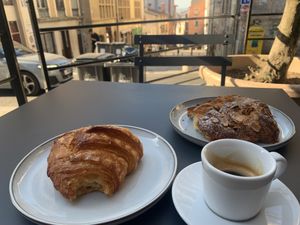 Croissant, espresso, croissant aux amandes on the patio at Zoï Kitchen - La Boutique in Lyon