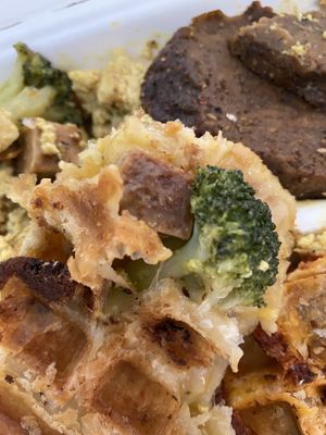 Ham and cheese stuffed waffle with scramble and sausage on the side  at The Greener Kitchen in Baltimore