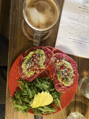 Flat white with coconut and beetroot hummus avocado toast  at Panenská Kaviareň in Bratislava