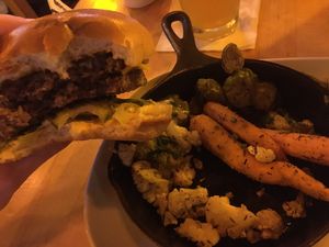 Partial devoured Impossible burger with side of grilled veggies (replacing default fries for $2 more). Picture doesn’t do the taste justice!  at House of Blues in Lake Buena Vista