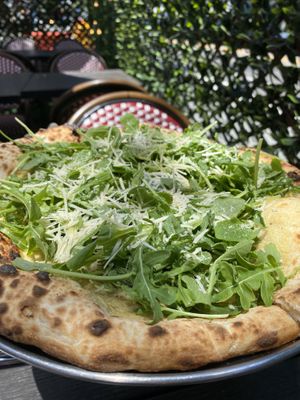 Amelia white pizza with cashew cream  macadam parm and arugula   at Pura Vita in West Hollywood