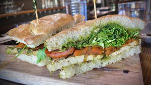 ANGELICA'S PANINI 
Grilled citrus herb tofu, caramelized onion and carrots, arugula, roasted garlic cashew aioli, pesto, rustic bread 🥖   at Pura Vita in West Hollywood