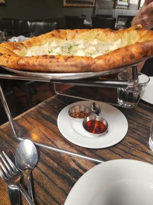 Cheese pizza with chilli flakes and oil at Pura Vita in West Hollywood