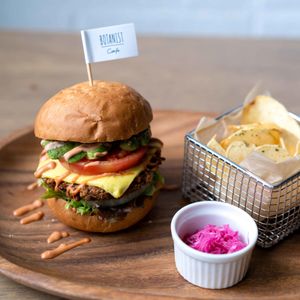 Renewed vegan burger with vegan cheese, avocado and tomato. Chips and pickled red cabbage on the side. at Botanist in Tokyo