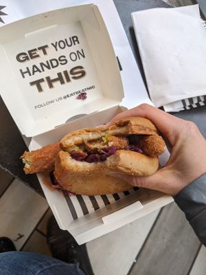 Hot Chiky sandwich on a gluten free bun one bite in :) at Beatnic - Back Bay in Boston