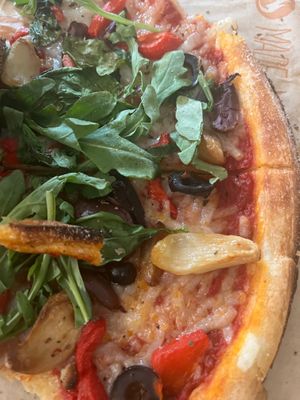 Classic dough, red sauce, vegan cheese, black olives, kalamata olives, roasted garlic, roasted red peppers, spinach, arugula, and oregano ($13.99 Build Your Own Pizza)  at Blaze Pizza in Bay Shore