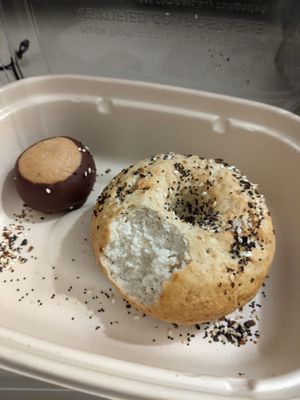 Buckeye (chocolate covered peanut butter ball) and an everything bagel with a bite taken out :) at Rise Authentic Baking Co in Grand Rapids
