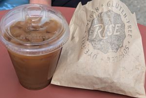 Cold brew coffee with oat milk. Apple fritter in the bag. at Rise Authentic Baking Co in Grand Rapids