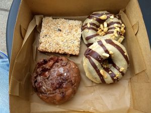 Magic bar, chocolate peanut butter donuts, apple fritter. at Rise Authentic Baking Co in Grand Rapids