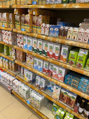 A whole wall of non dairy milks 💚 at Naturalia - Bezons in Courbevoie