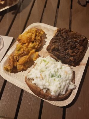 Magical bbq sandwich with slaw on top and magical potato salad! at Magic Vegan Cafe in Gulfport