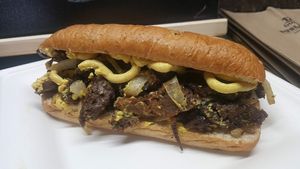 Steak and Cheese Sandwich- Homemade steak strips and grilled onions on a whole wheat hoagie bun with a generous amount of our homemade cheese at Magic Vegan Cafe in Gulfport