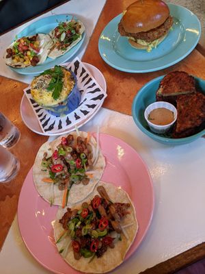 Hoisin duck tacos, mac and cheese, aubergine fritters and chicken burger at Genesis Plant Based Alchemy in North London
