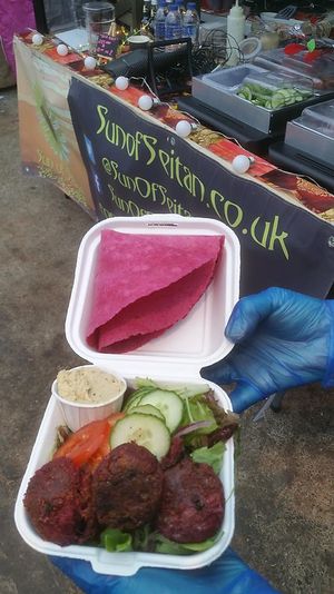 Gluten free beetroot falafels with lemon and coriander hummus, salad in beetroot gluten free wraps.  at Sun of Seitan in Newcastle Upon Tyne