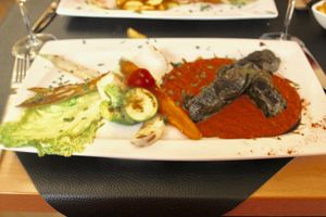 Stuffed grape leaves with kidney beans on tomato and pepper at Au Goût du Jour in Eupen