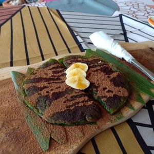 Vegan Pancakes topped with cacao, banana and syrup. at Ayo Vegan - Peliatan in Ubud
