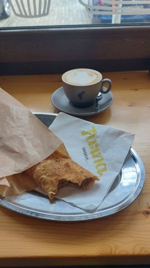 Apple, walnut and cinnamon banitsa with a very good oat cappuccino. at Furna in Sofia
