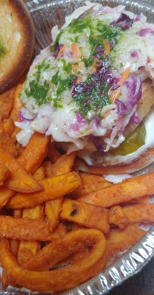 The vegan "chicken" burger with vegan slaw, pesto, vegan mayo, pickles and tomato served with sweet potato fries 😍😍😍 at Harvest Room in Munster