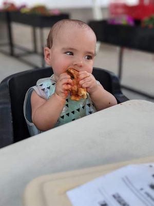 My little enjoying her slice of pie.  at &pizza in Gaithersburg