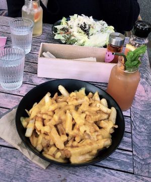 Poutine (and caesar salad in background)! Front drink is the kombucha cocktail and back one is plain kombucha  at Good Love in St Kilda