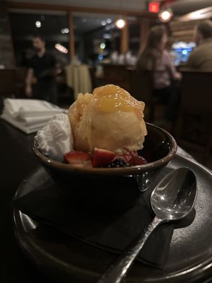 Peach and raspberry sorbet 🍧 with coconut 🥥 cream and they even brought more cream when I said I loved it   at The Juniper Bistro in Banff